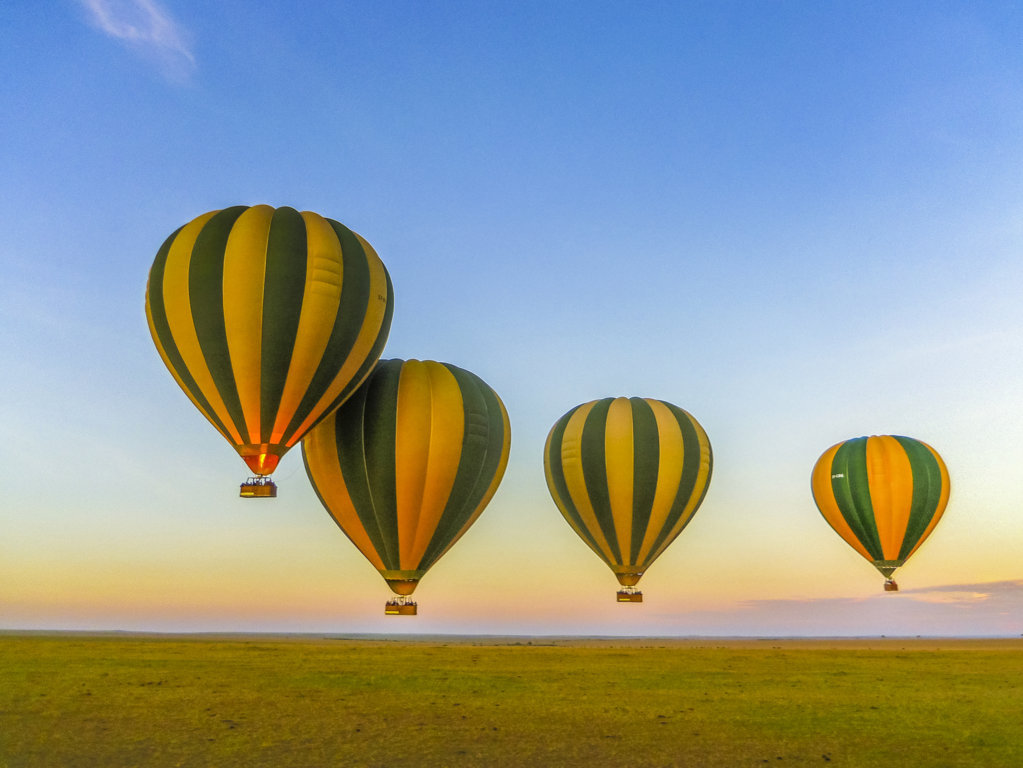 Hot Air Balloon Flying Across Savannah Landscape